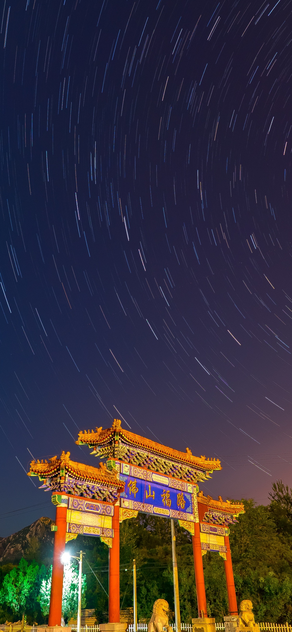 Brown Temple Under Blue Sky During Night Time. Wallpaper in 1125x2436 Resolution