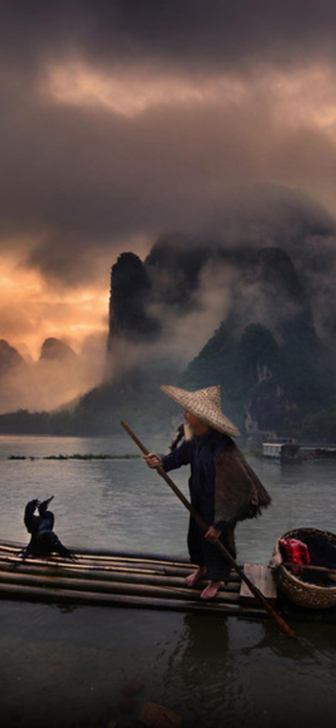 Man Riding on Boat on Lake During Sunset. Wallpaper in 1125x2436 Resolution