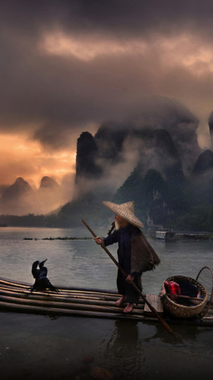 Man Riding on Boat on Lake During Sunset. Wallpaper in 750x1334 Resolution