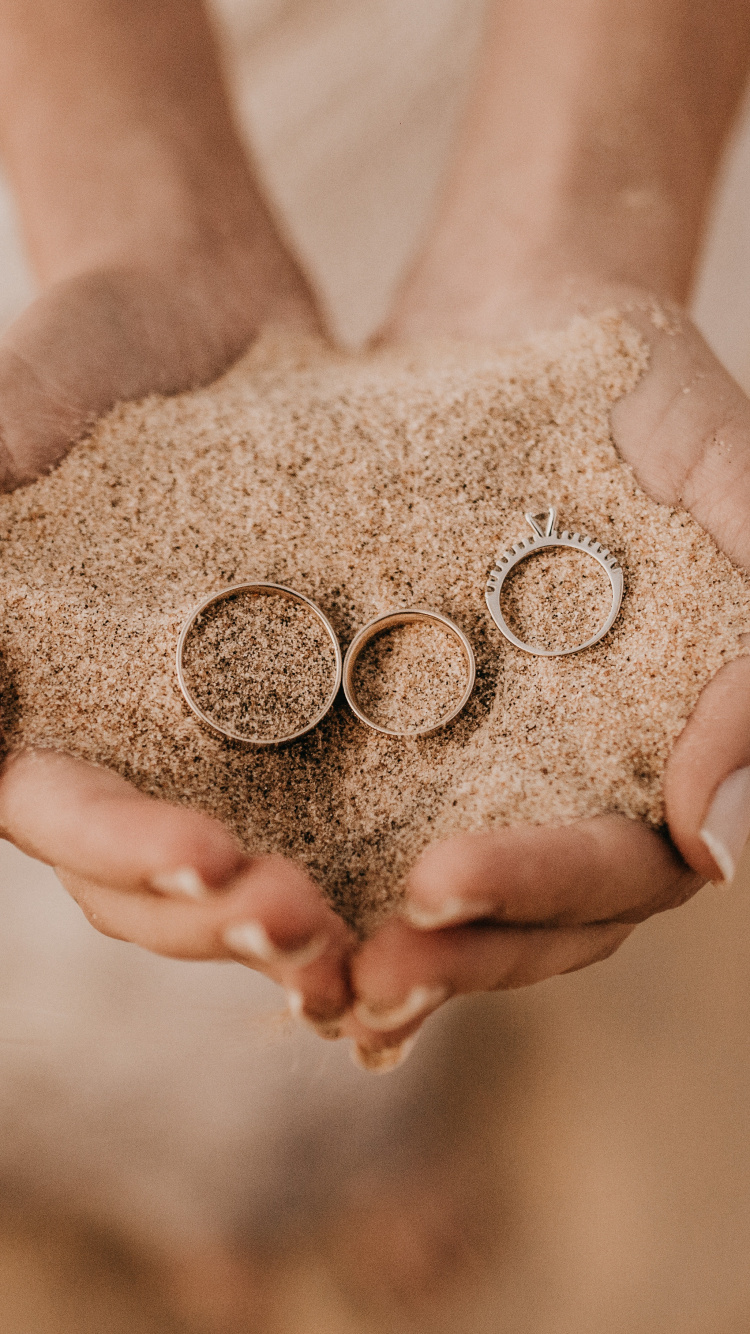 Person Holding Brown Sand on Top of White Textile. Wallpaper in 750x1334 Resolution