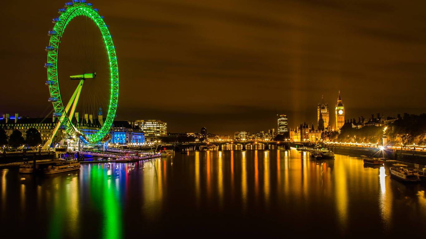 Riesenrad in Der Nähe Von Stadtgebäuden Während Der Nacht. Wallpaper in 1366x768 Resolution
