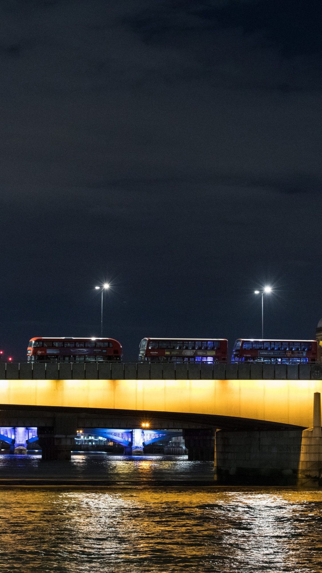Lighted Bridge Over Water During Night Time. Wallpaper in 1080x1920 Resolution