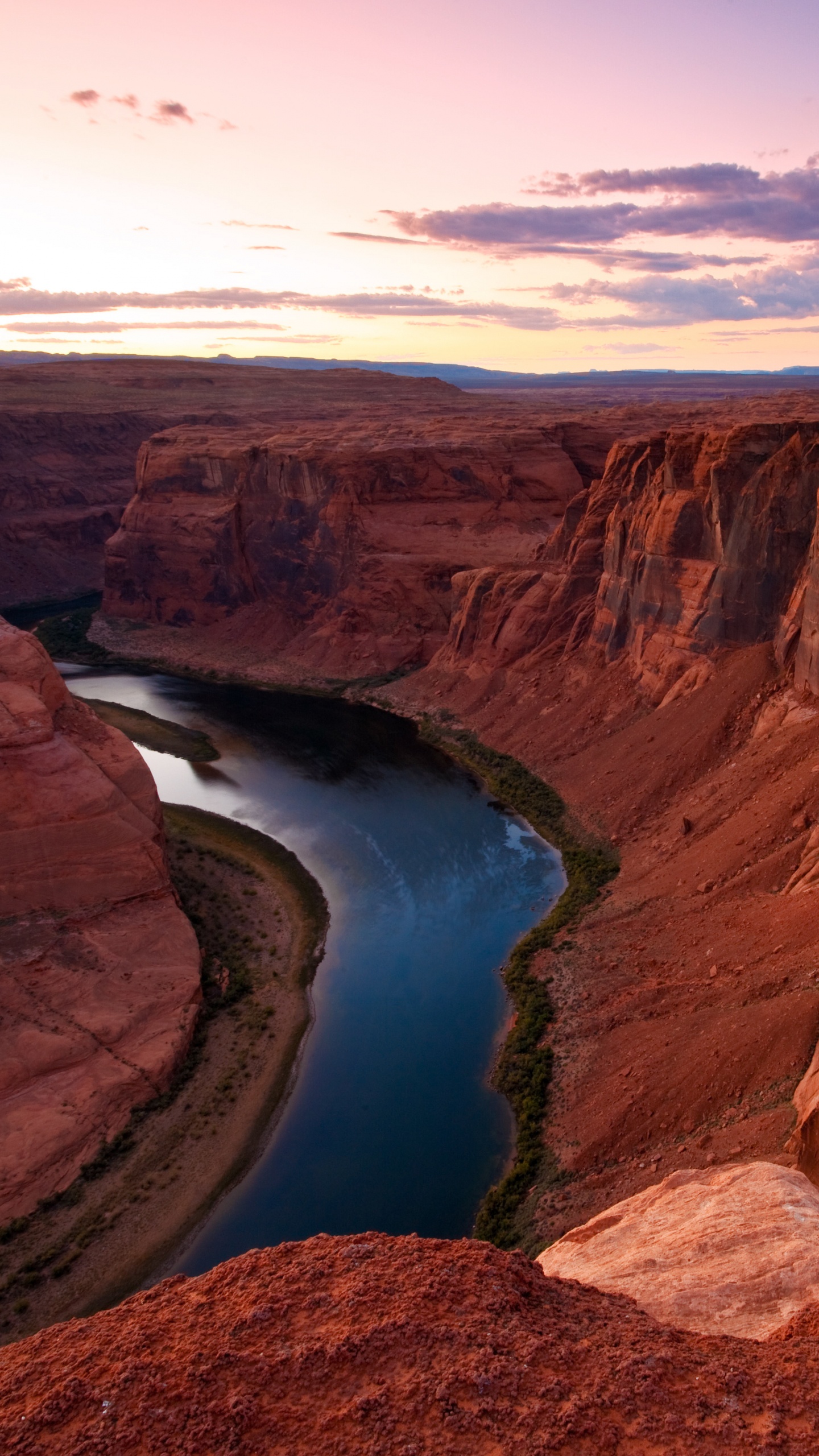 Brown Rock Formation Near Blue Lake Under Blue Sky During Daytime. Wallpaper in 1440x2560 Resolution