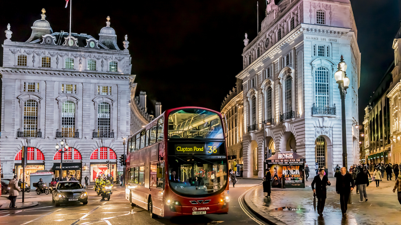 Red and Black Bus on Road Near Brown Concrete Building During Nighttime. Wallpaper in 1366x768 Resolution