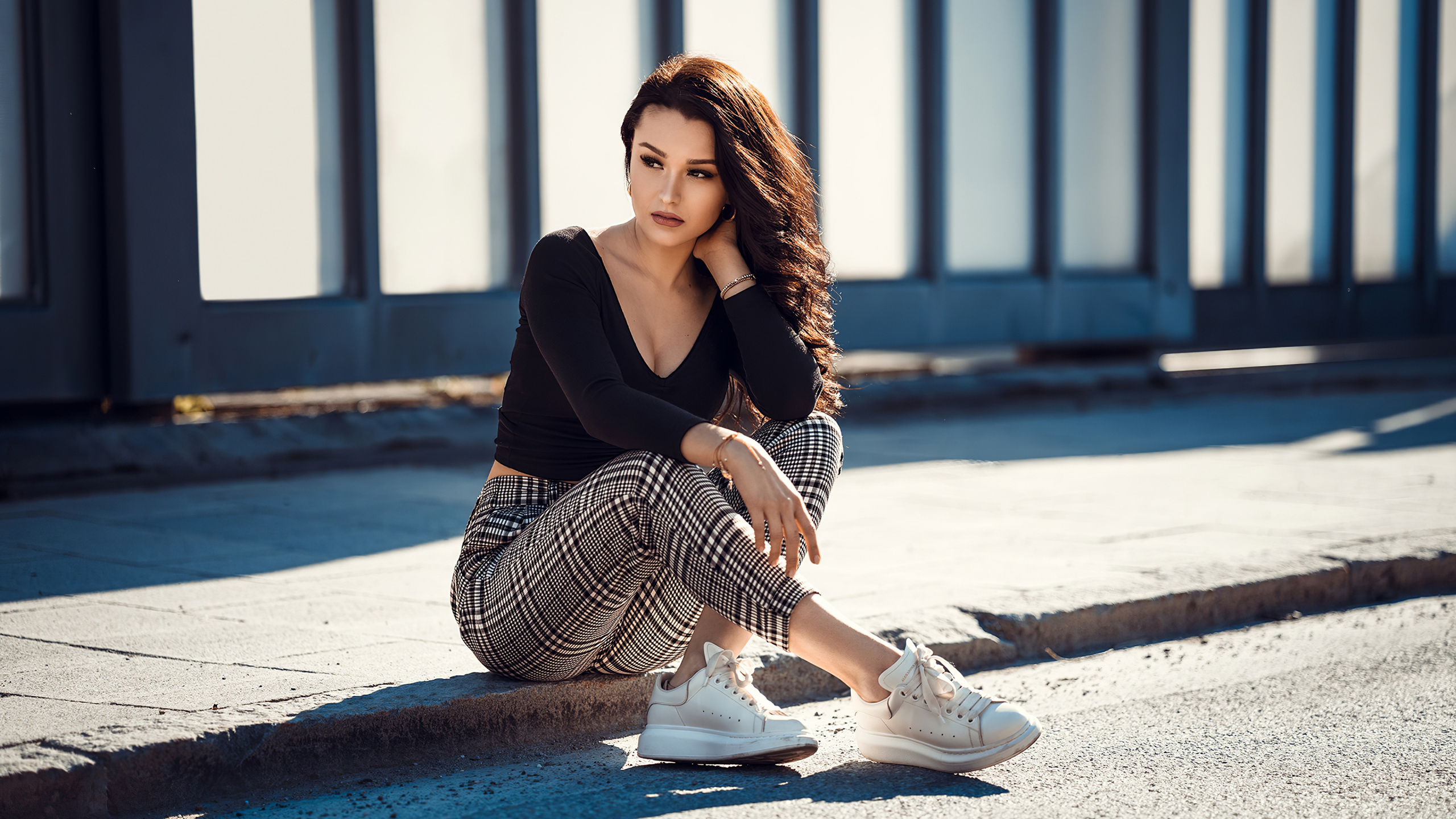 Woman in Black Long Sleeve Shirt and Black and White Striped Skirt Sitting on Concrete Floor. Wallpaper in 2560x1440 Resolution