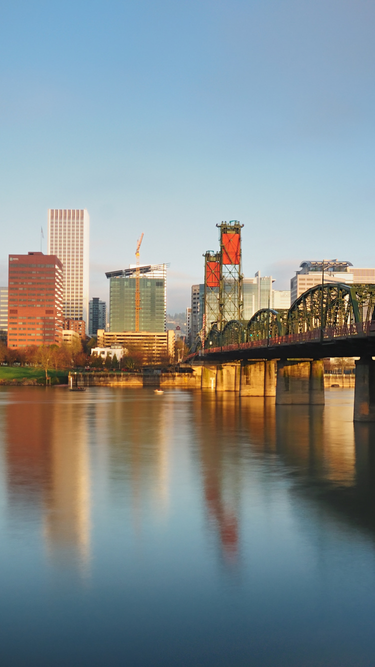 City Skyline Across Body of Water During Daytime. Wallpaper in 750x1334 Resolution