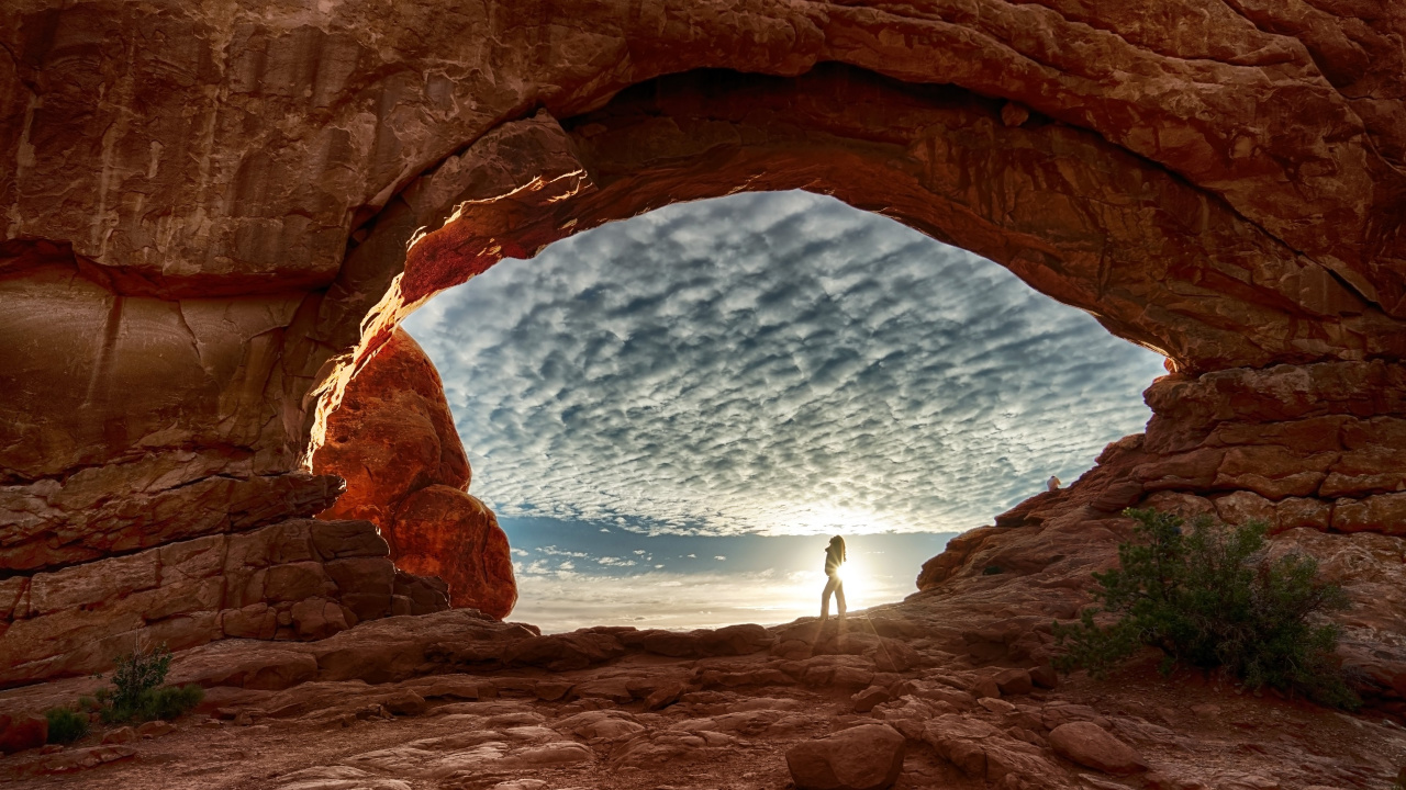 Person Standing on Brown Rock Formation During Daytime. Wallpaper in 1280x720 Resolution