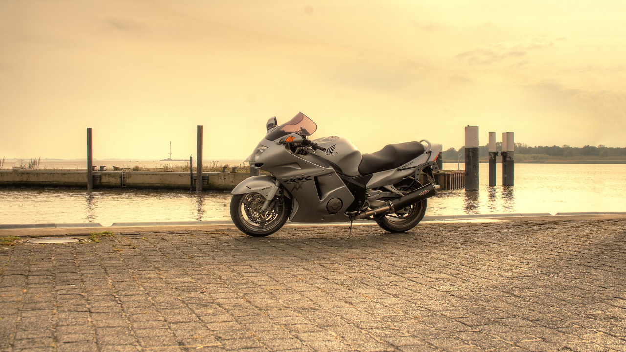 Black Motorcycle Parked on Gray Concrete Pavement During Daytime. Wallpaper in 1280x720 Resolution