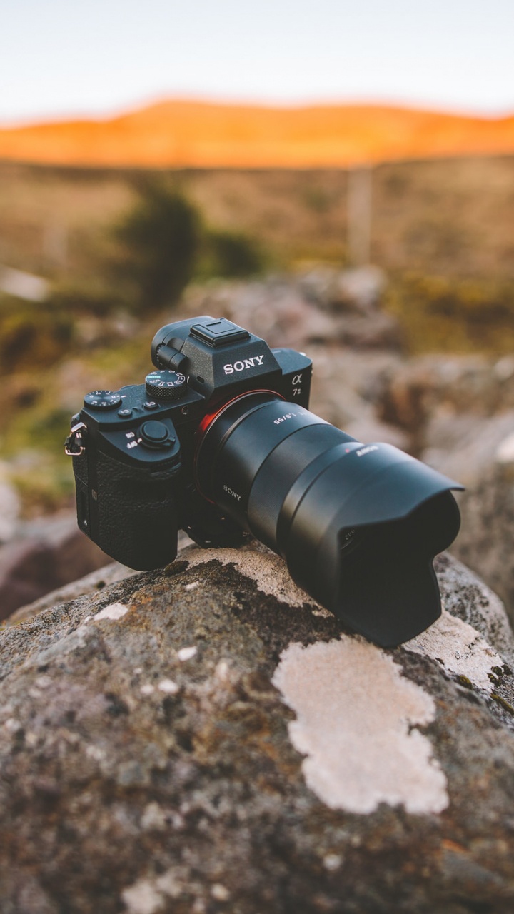 Black Dslr Camera on Rock. Wallpaper in 720x1280 Resolution