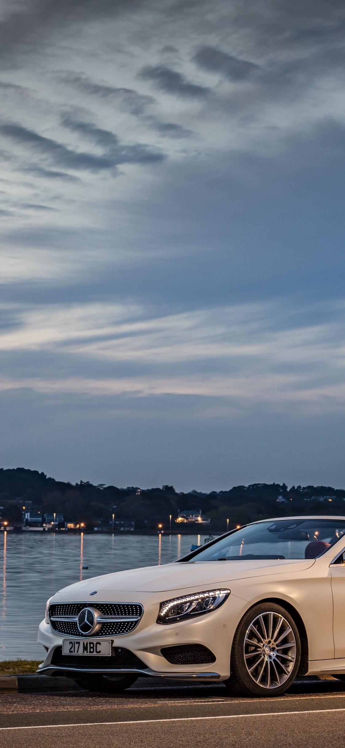 White Mercedes Benz Coupe Parked Near Body of Water During Daytime. Wallpaper in 1125x2436 Resolution
