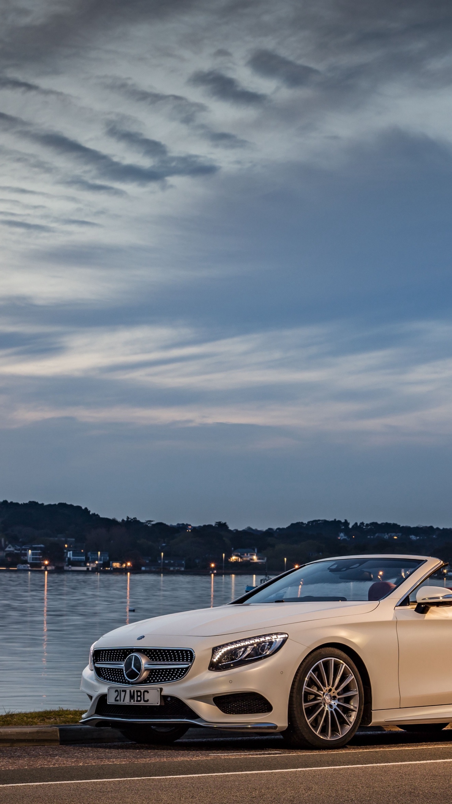 White Mercedes Benz Coupe Parked Near Body of Water During Daytime. Wallpaper in 1440x2560 Resolution