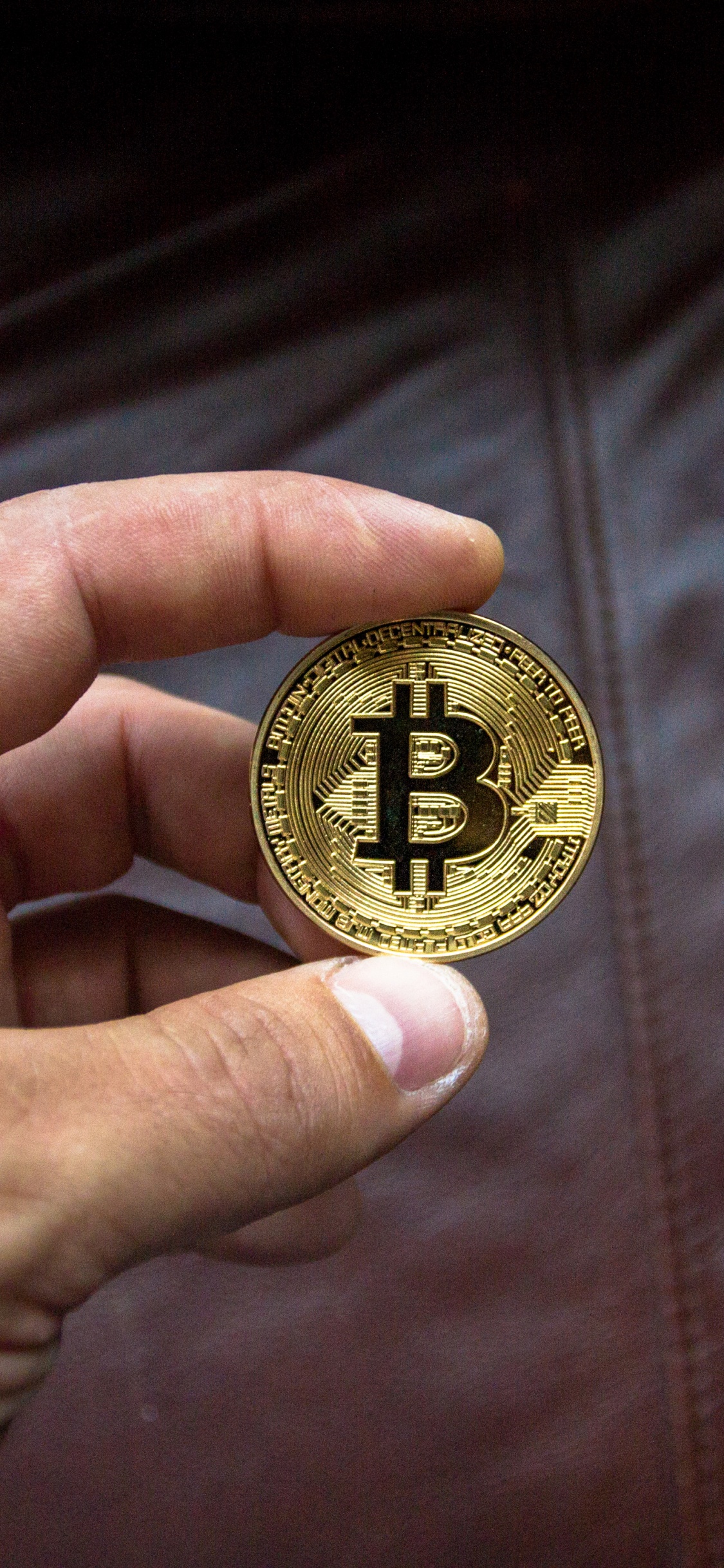 Gold Round Coin on Brown Leather Textile. Wallpaper in 1125x2436 Resolution
