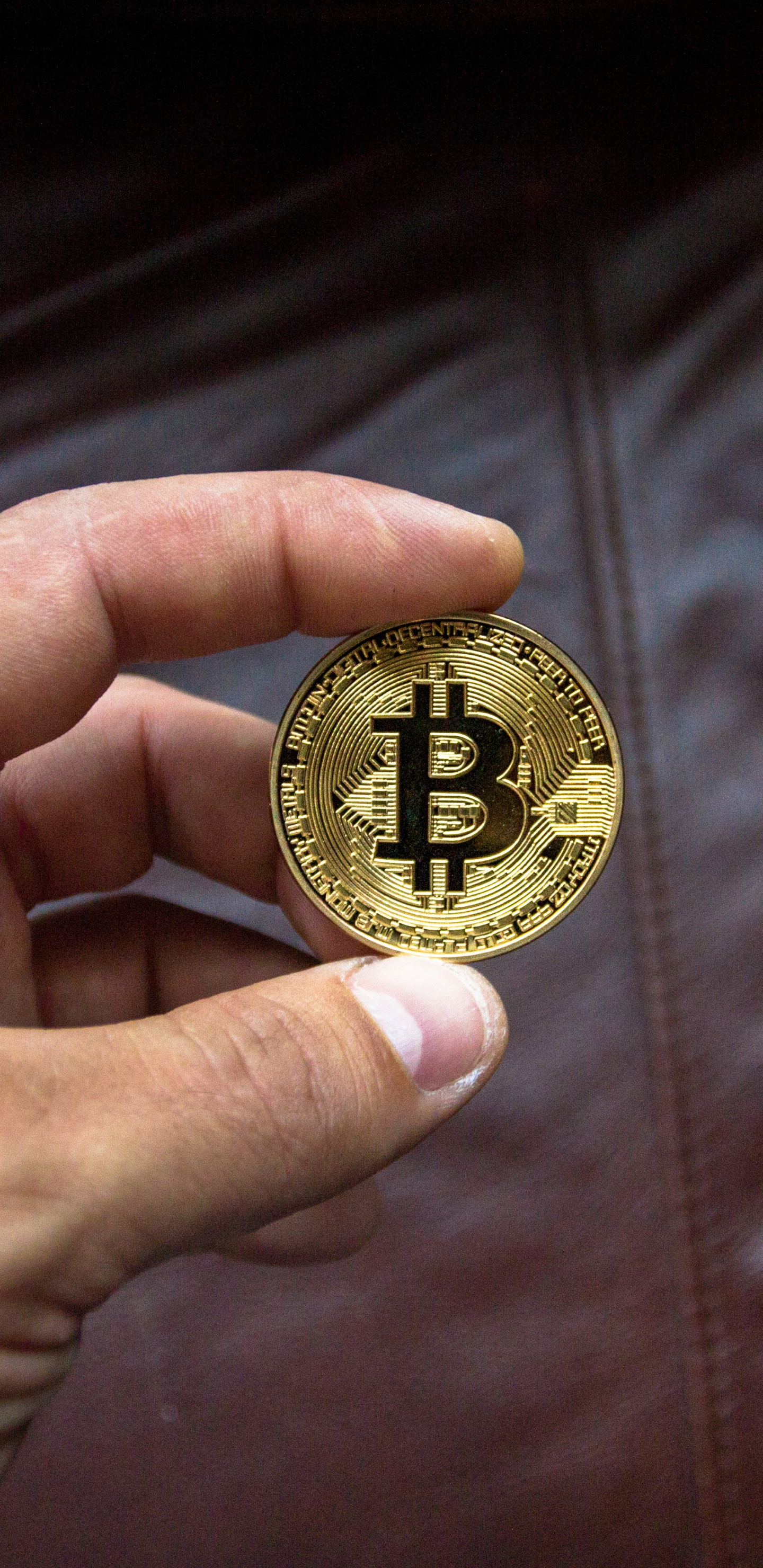 Gold Round Coin on Brown Leather Textile. Wallpaper in 1440x2960 Resolution