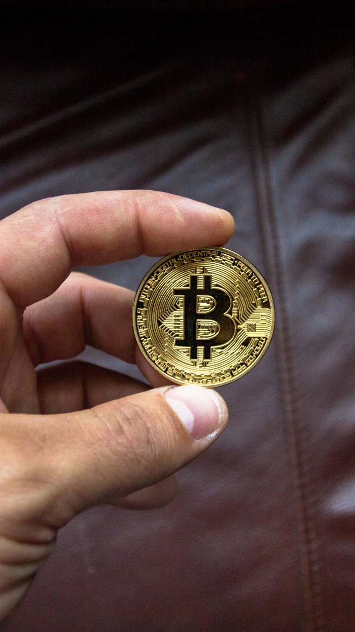 Gold Round Coin on Brown Leather Textile. Wallpaper in 720x1280 Resolution