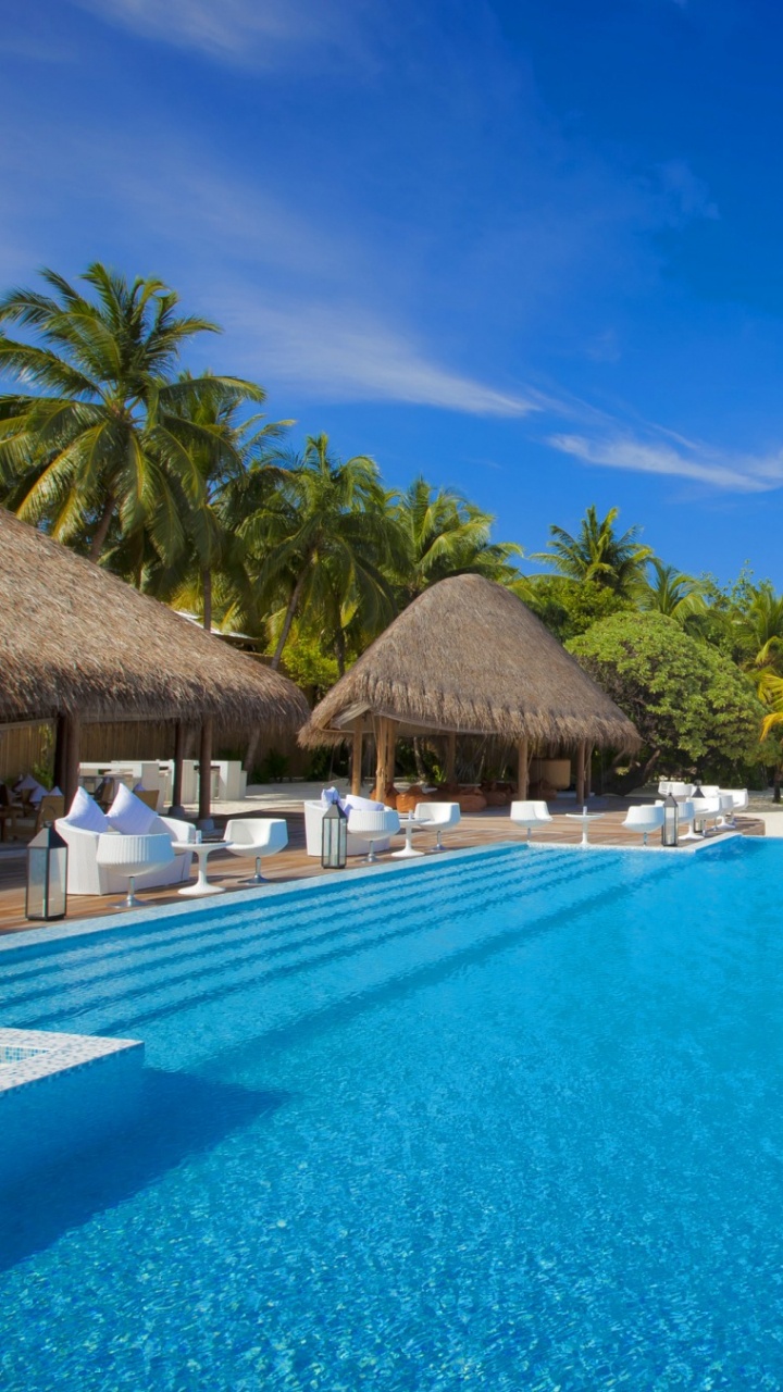 Brown Wooden Beach Lounge Chairs Near Swimming Pool During Daytime. Wallpaper in 720x1280 Resolution