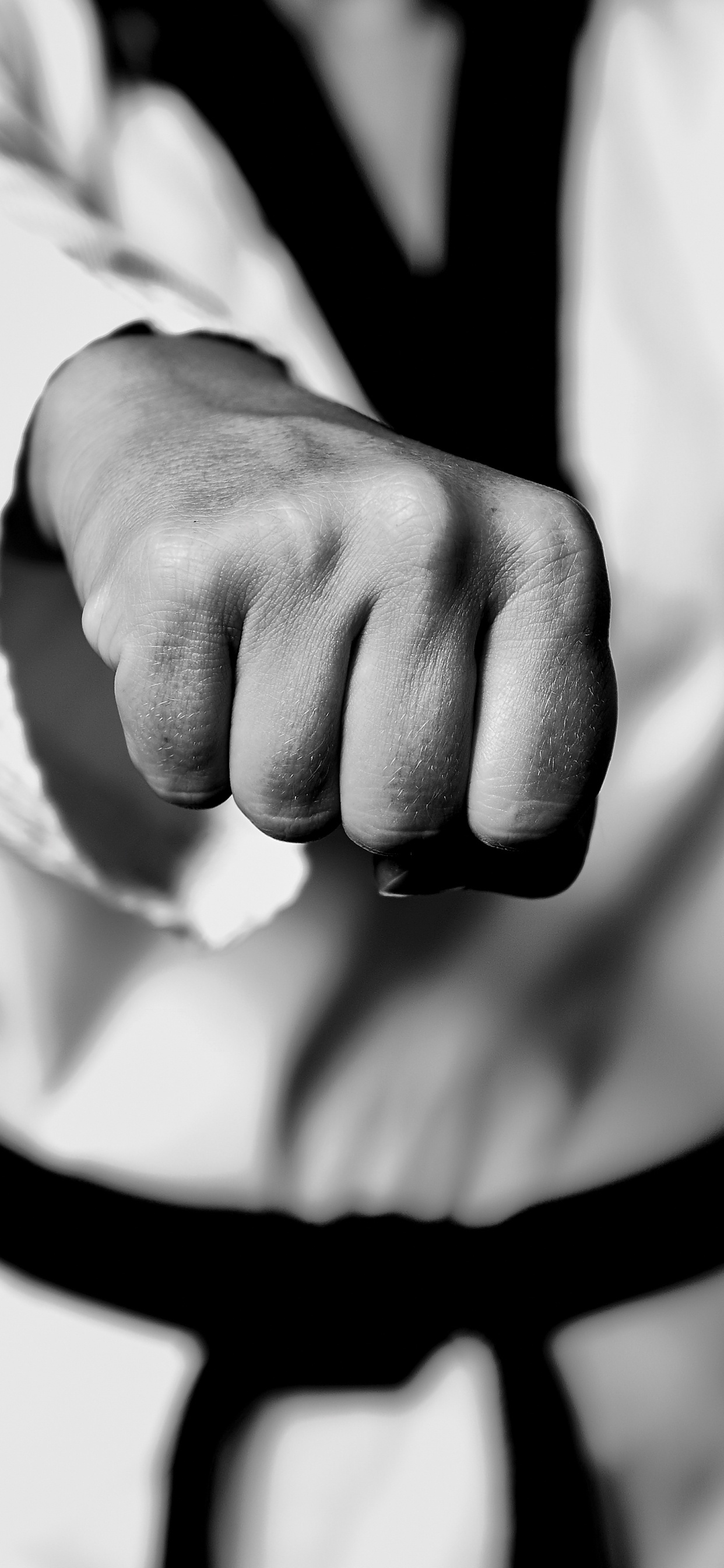 Grayscale Photo of Person Holding Black Strap. Wallpaper in 1242x2688 Resolution