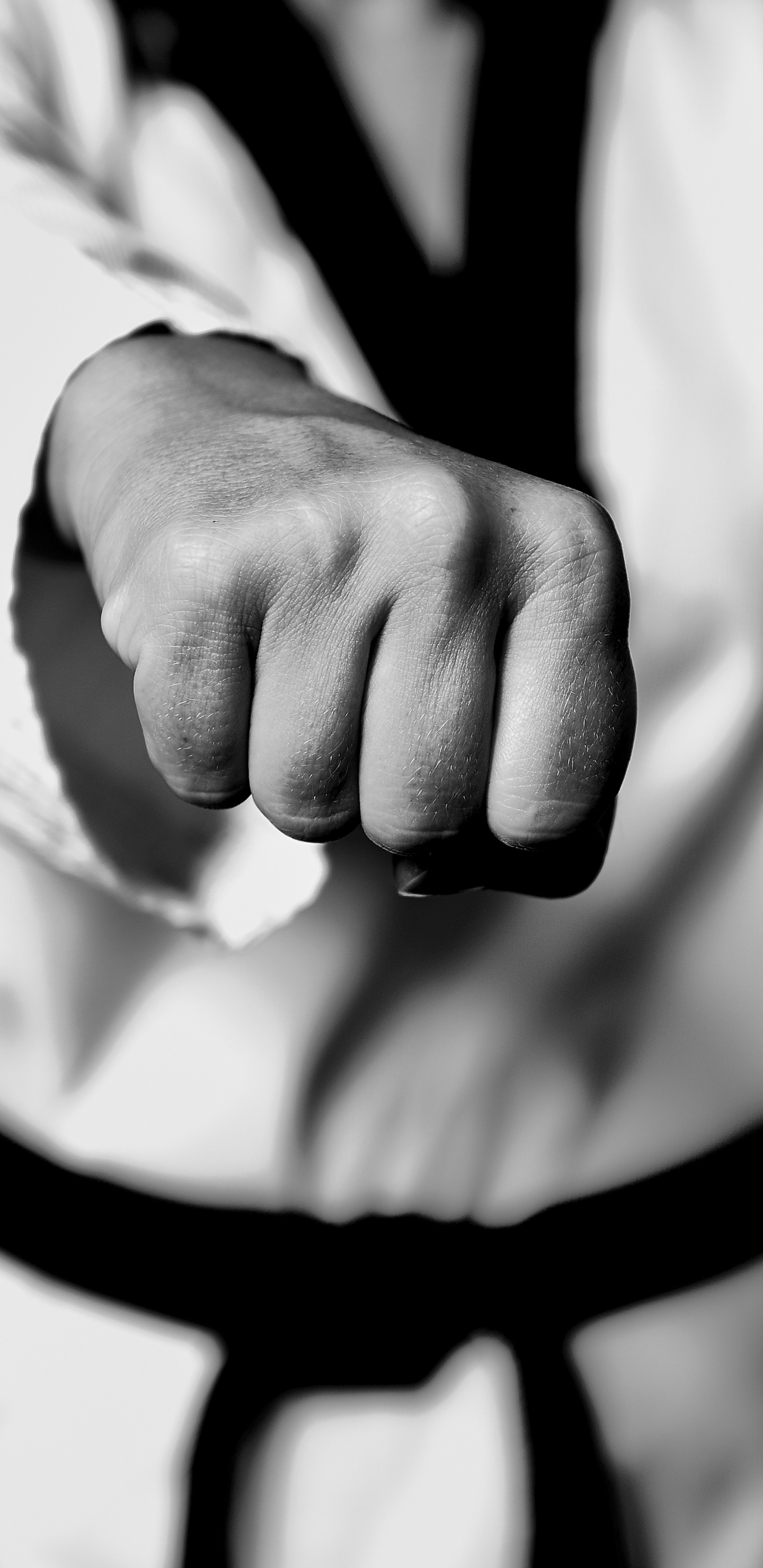 Grayscale Photo of Person Holding Black Strap. Wallpaper in 1440x2960 Resolution