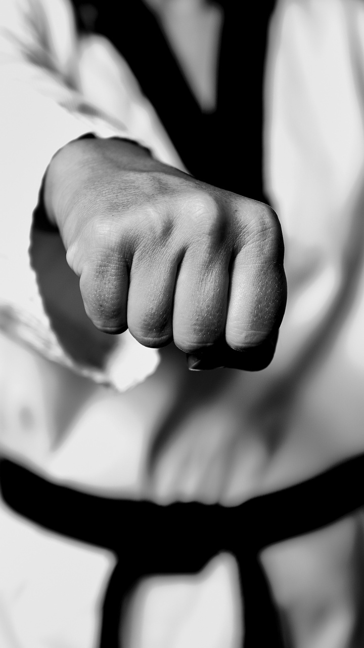 Grayscale Photo of Person Holding Black Strap. Wallpaper in 720x1280 Resolution