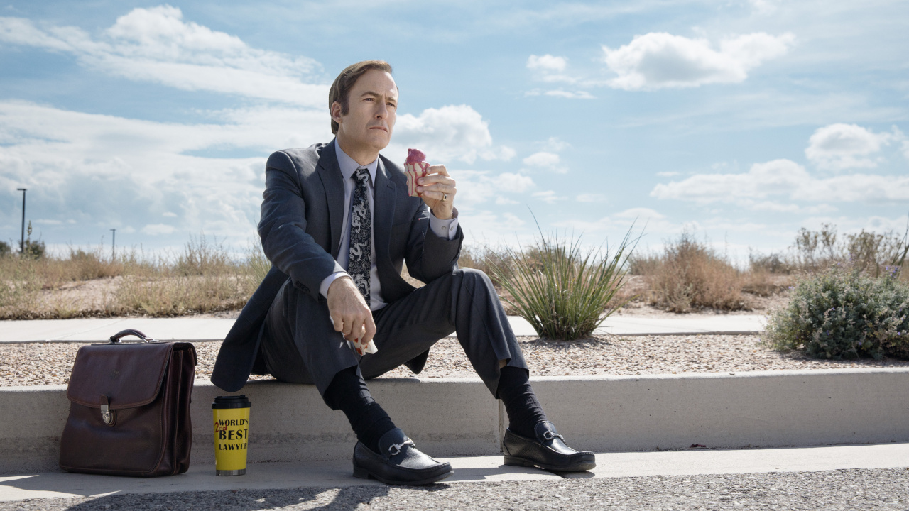 Man in Black Leather Jacket Sitting on Yellow Plastic Trash Bin. Wallpaper in 1280x720 Resolution