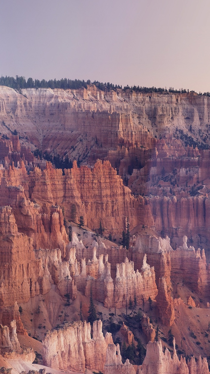 Brown Rocky Mountain Under White Sky During Daytime. Wallpaper in 720x1280 Resolution