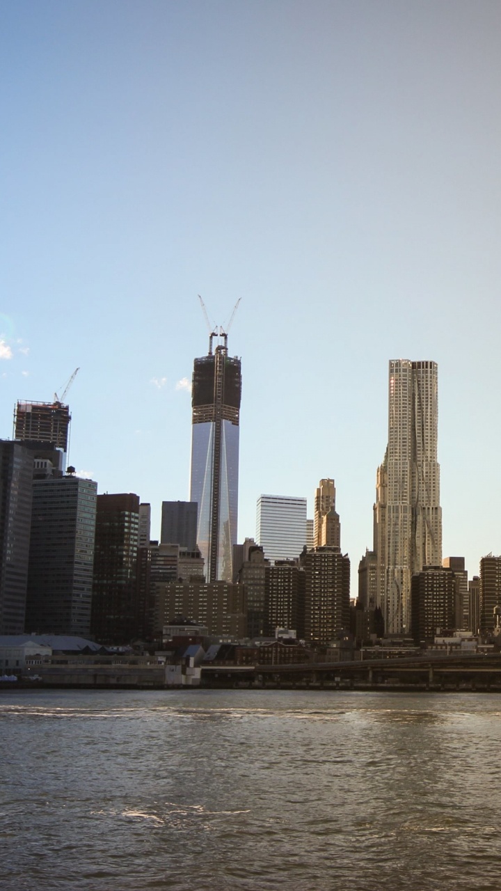City Skyline Across Body of Water During Daytime. Wallpaper in 720x1280 Resolution