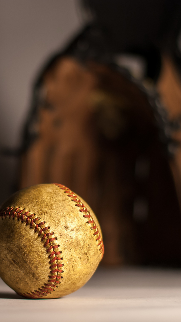 Brown Baseball on Brown Wooden Table. Wallpaper in 750x1334 Resolution