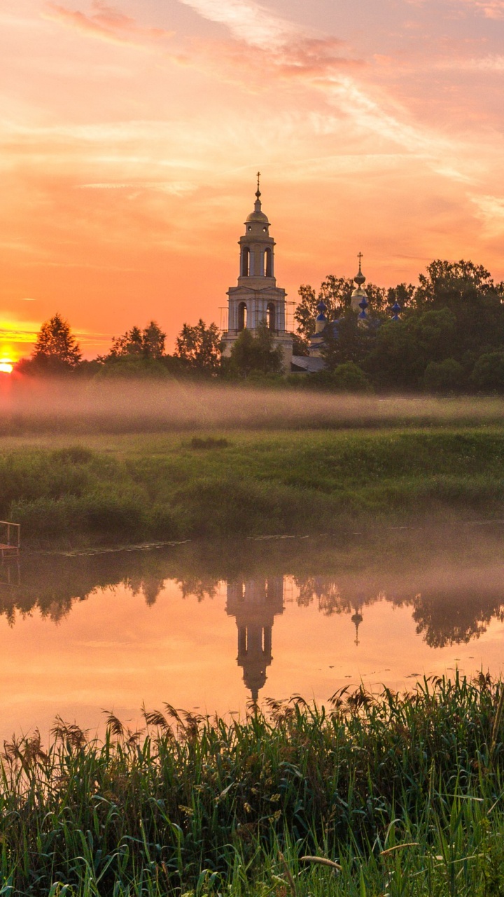 Grüne Wiese in Der Nähe Von Gewässern Während Des Sonnenuntergangs. Wallpaper in 720x1280 Resolution