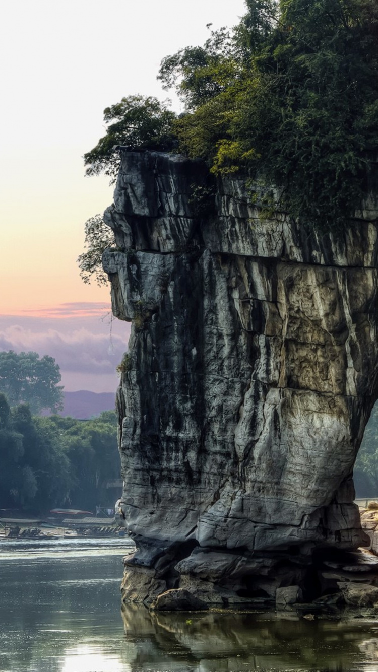Gray Rock Formation Near Body of Water During Daytime. Wallpaper in 750x1334 Resolution
