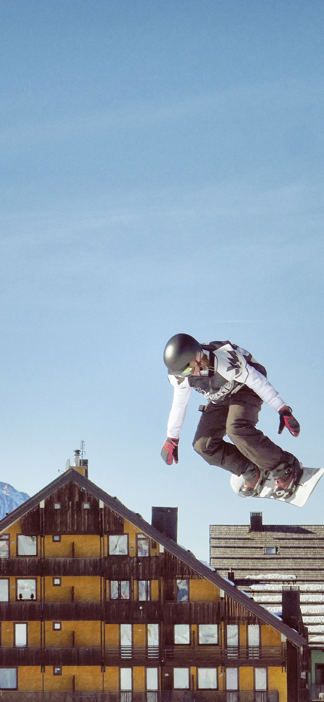 Man in White Jacket and Black Pants Jumping on Mid Air During Daytime. Wallpaper in 1125x2436 Resolution