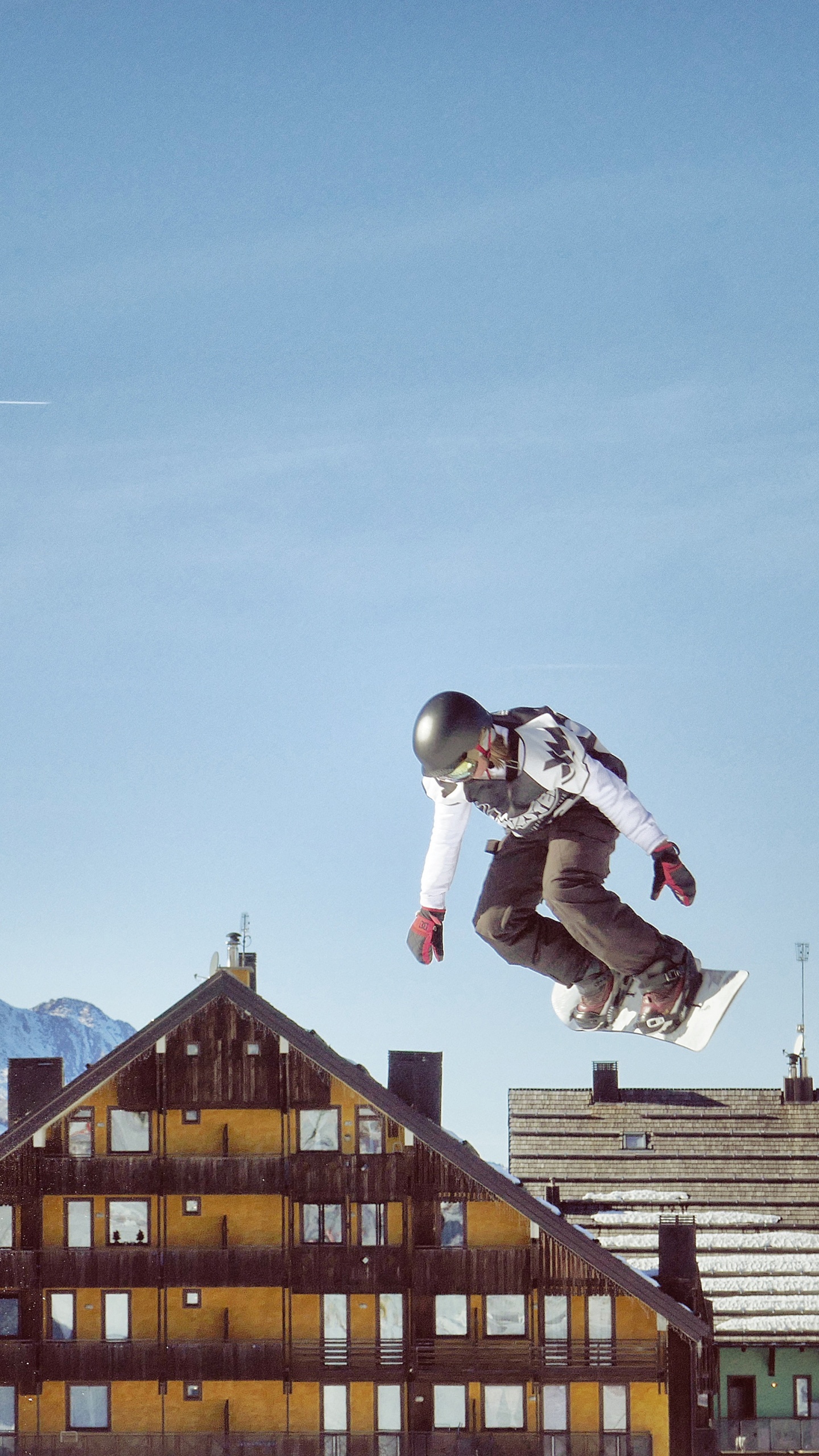 Homme en Veste Blanche et Pantalon Noir Sautant Dans Les Airs Pendant la Journée. Wallpaper in 1440x2560 Resolution