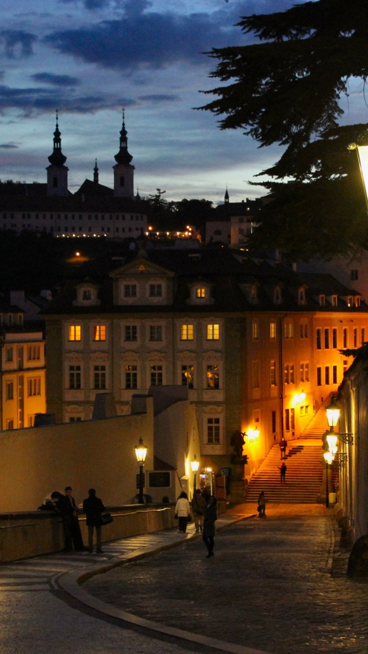 People Walking on Sidewalk Near Building During Night Time. Wallpaper in 720x1280 Resolution