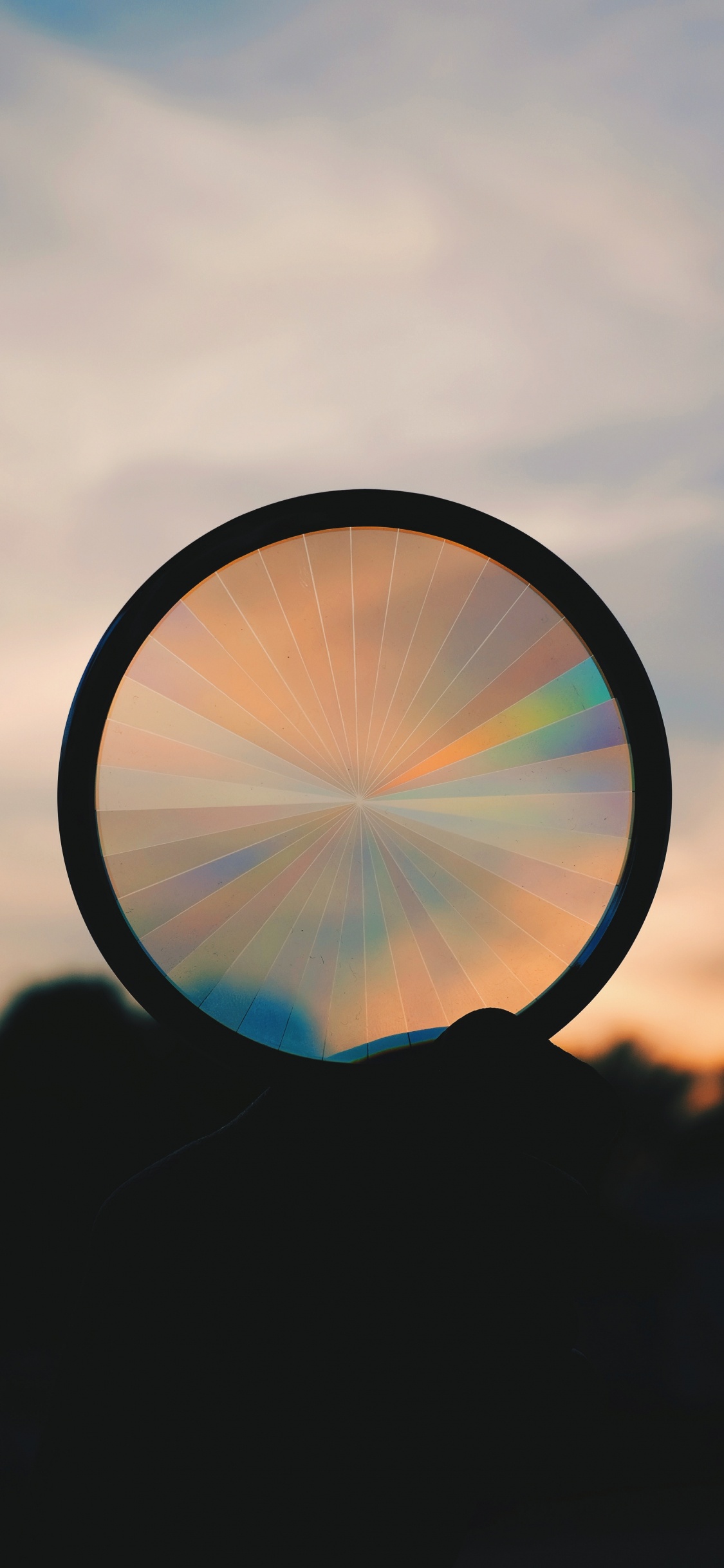 Silhouette of Round Mirror With Sun Rays. Wallpaper in 1125x2436 Resolution