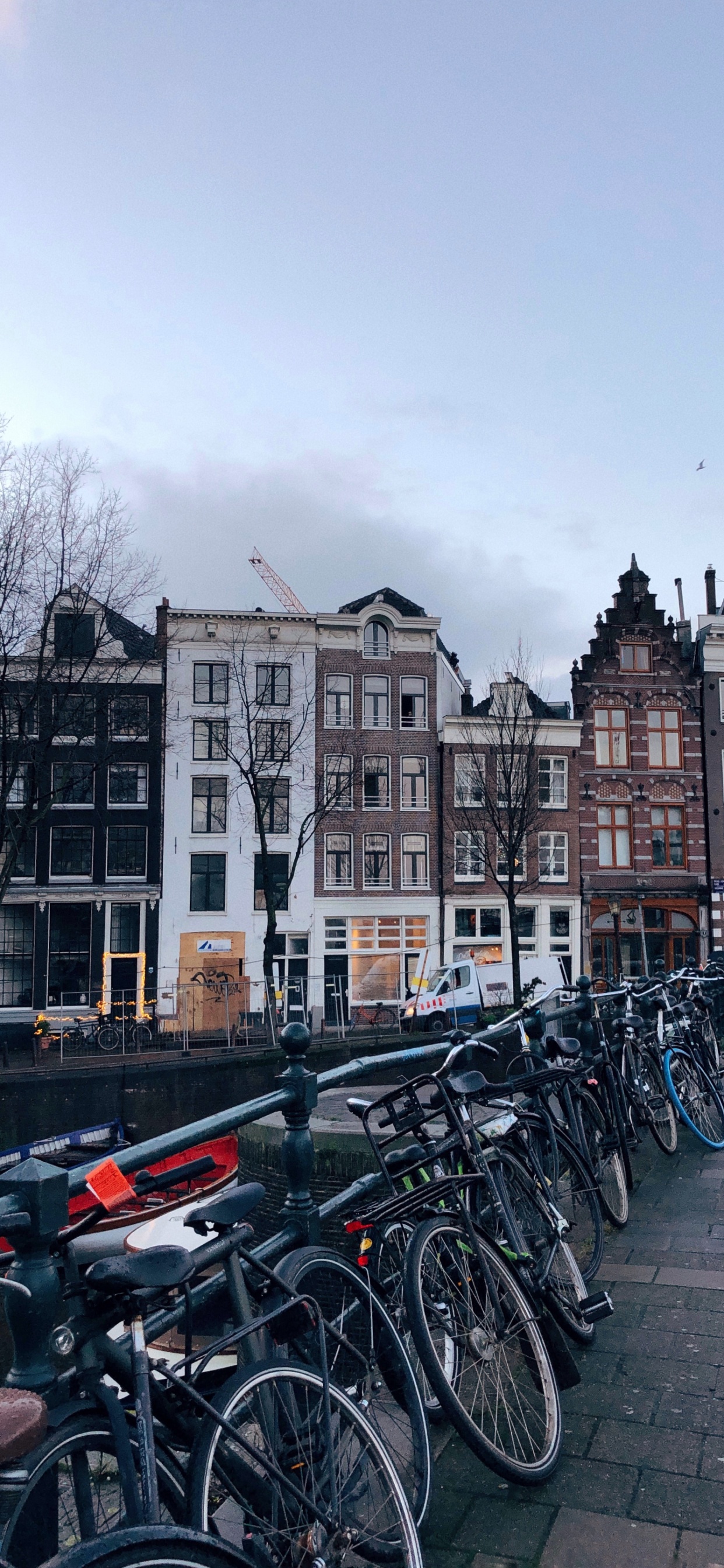 Bicycles Parked Beside Concrete Building During Daytime. Wallpaper in 1242x2688 Resolution