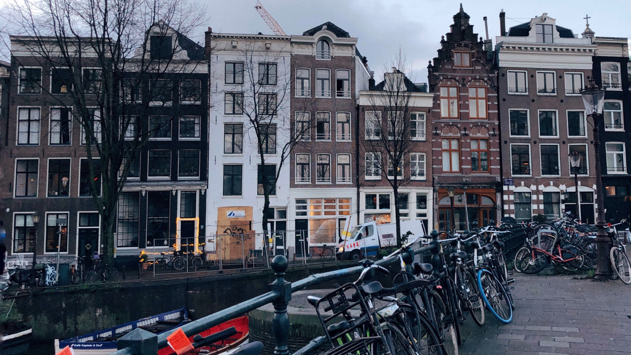 Bicycles Parked Beside Concrete Building During Daytime. Wallpaper in 1280x720 Resolution