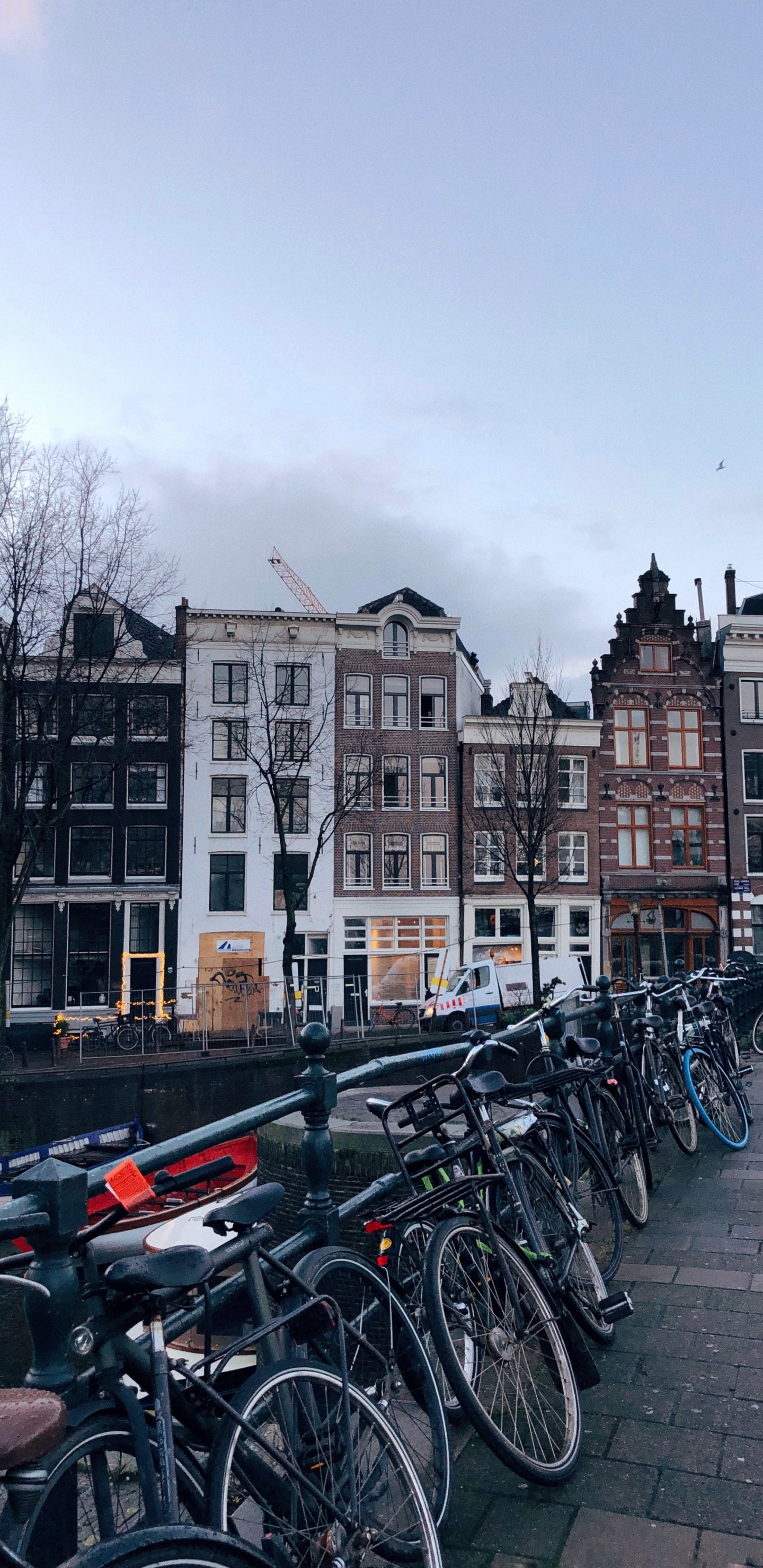 Bicycles Parked Beside Concrete Building During Daytime. Wallpaper in 1440x2960 Resolution