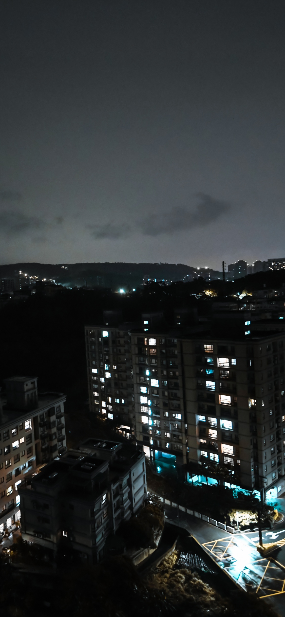 City Skyline During Night Time. Wallpaper in 1125x2436 Resolution