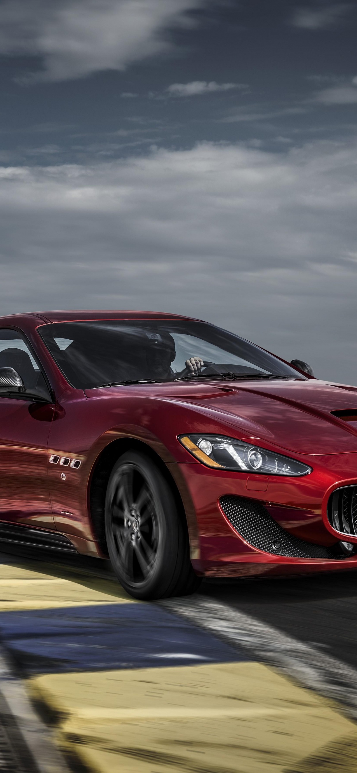 Red Porsche 911 on Road Under Cloudy Sky. Wallpaper in 1242x2688 Resolution