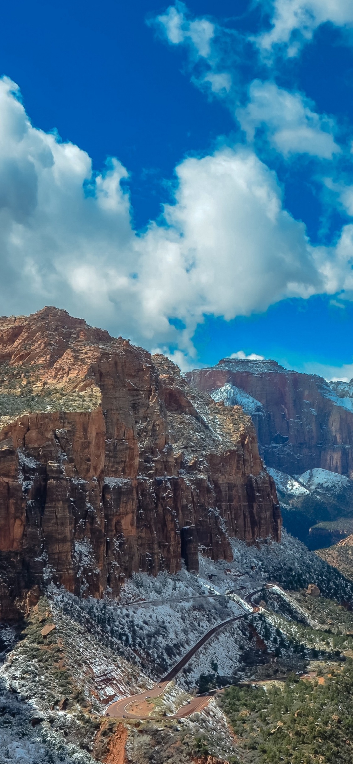 Brown Rocky Mountain Under Blue Sky During Daytime. Wallpaper in 1125x2436 Resolution