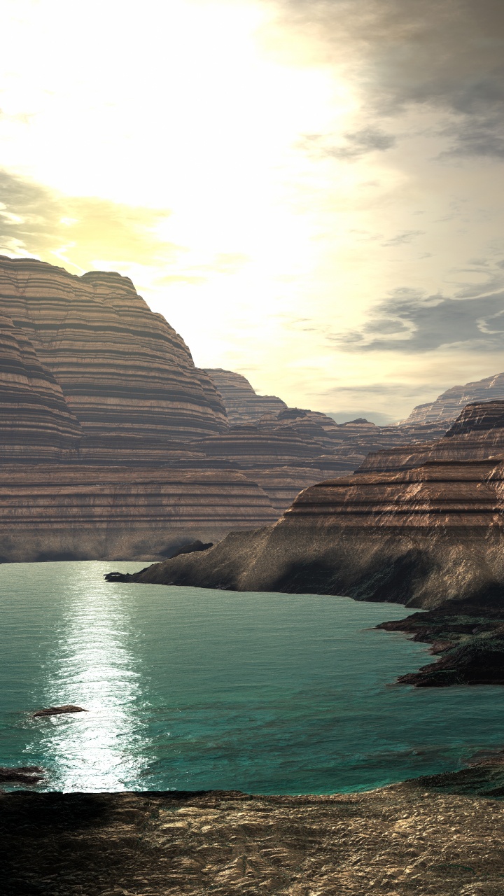 Montagne Rocheuse Brune à Côté D'un Plan D'eau Pendant la Journée. Wallpaper in 720x1280 Resolution