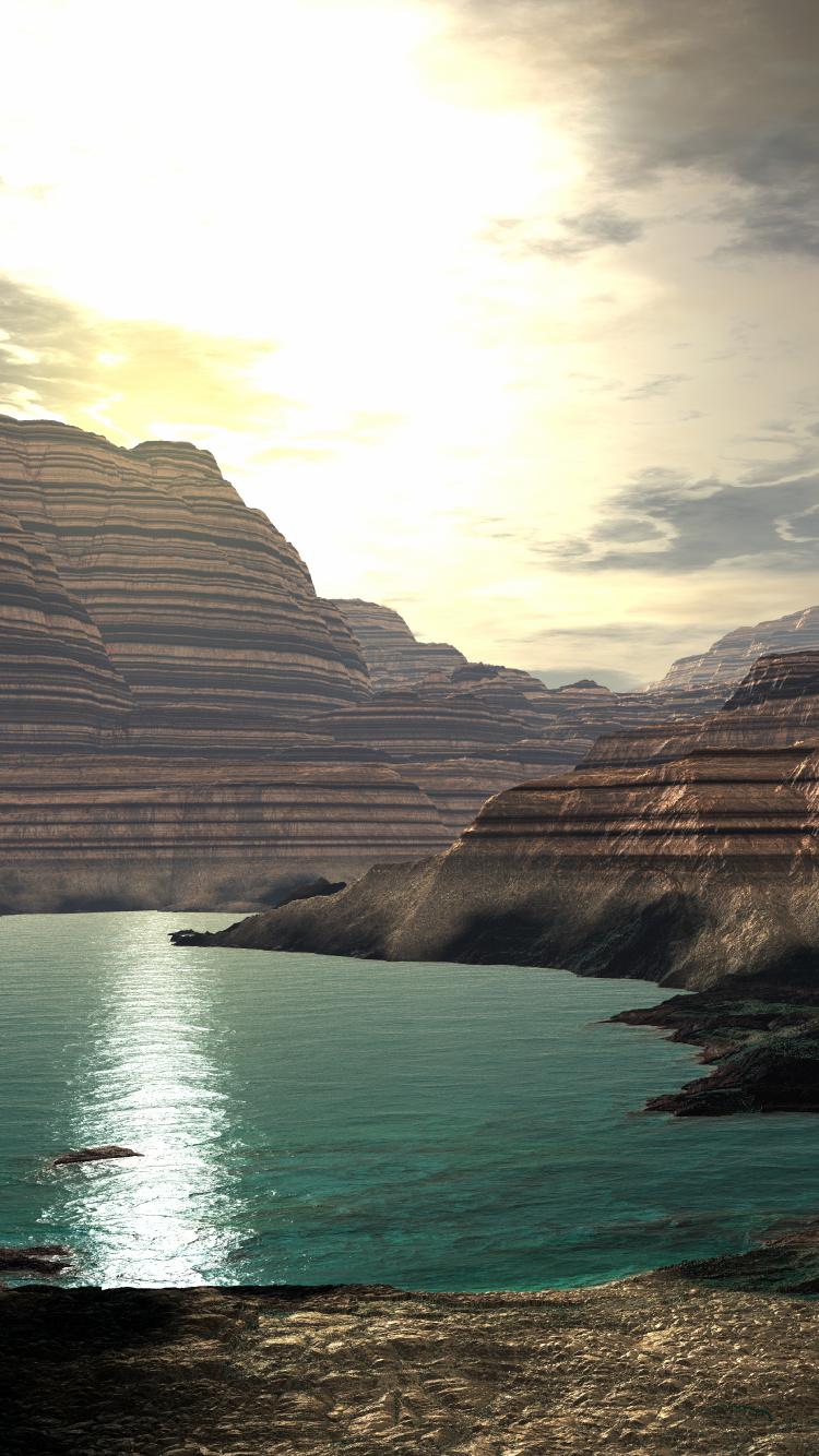 Brown Rocky Mountain Beside Body of Water During Daytime. Wallpaper in 750x1334 Resolution