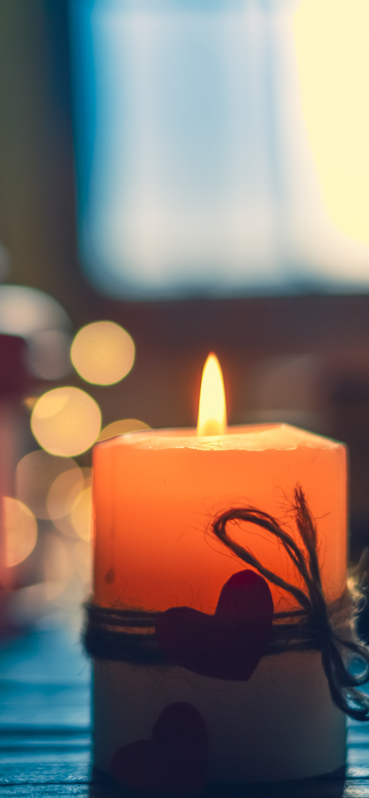 Lighted Candle on Black Metal Candle Holder. Wallpaper in 1242x2688 Resolution