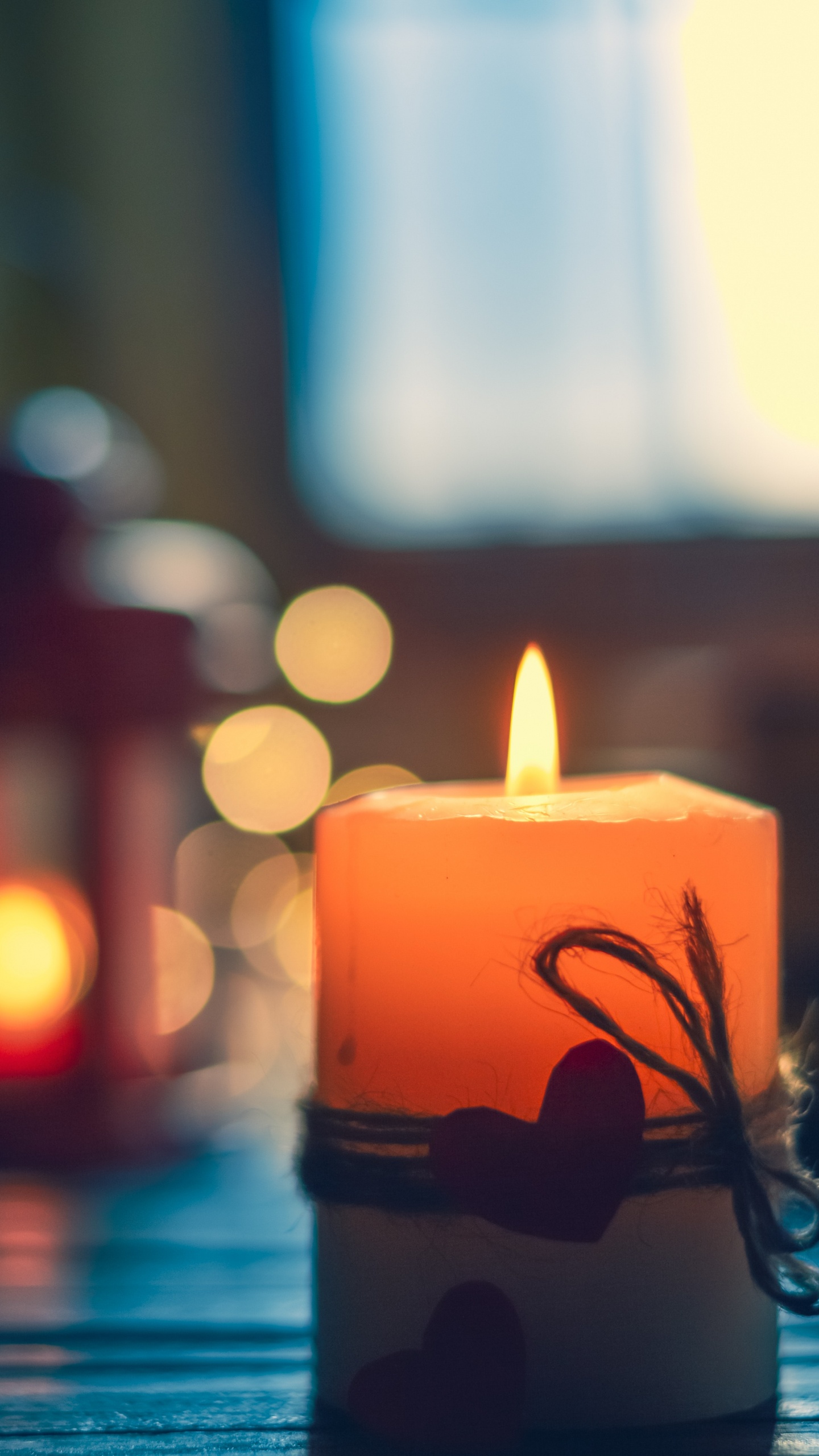 Lighted Candle on Black Metal Candle Holder. Wallpaper in 1440x2560 Resolution