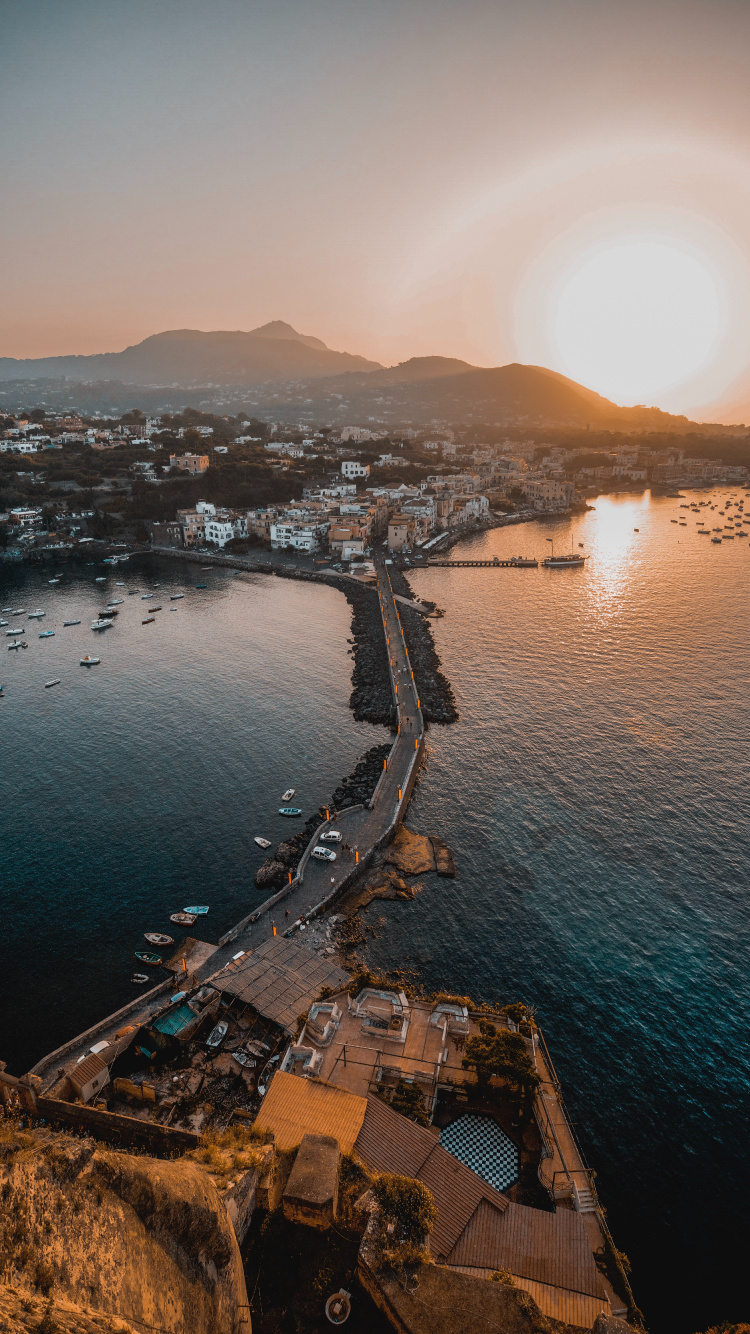 Aerial View of City Buildings Near Body of Water During Sunset. Wallpaper in 750x1334 Resolution