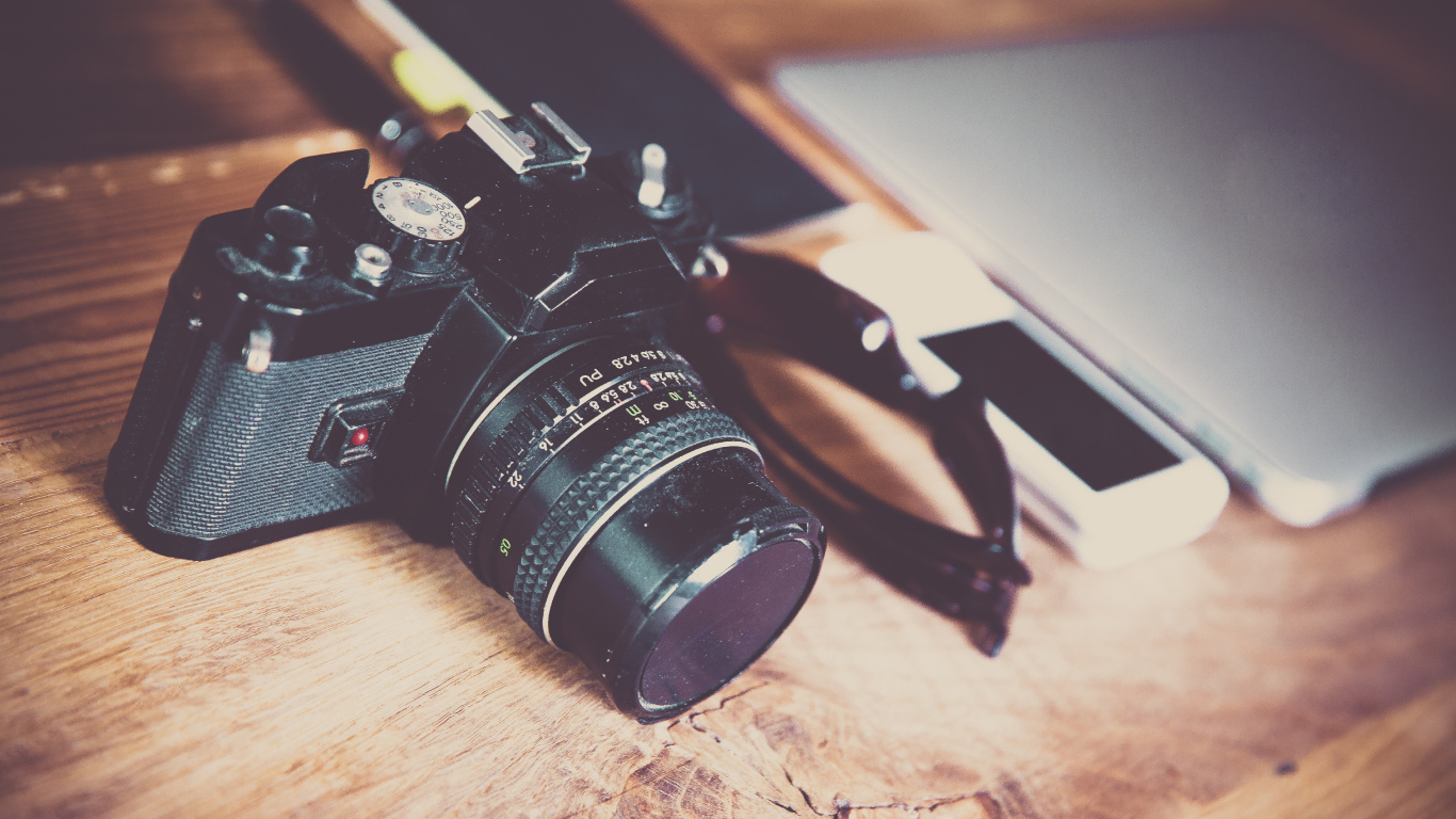 Black Nikon Dslr Camera on Brown Wooden Table. Wallpaper in 1366x768 Resolution