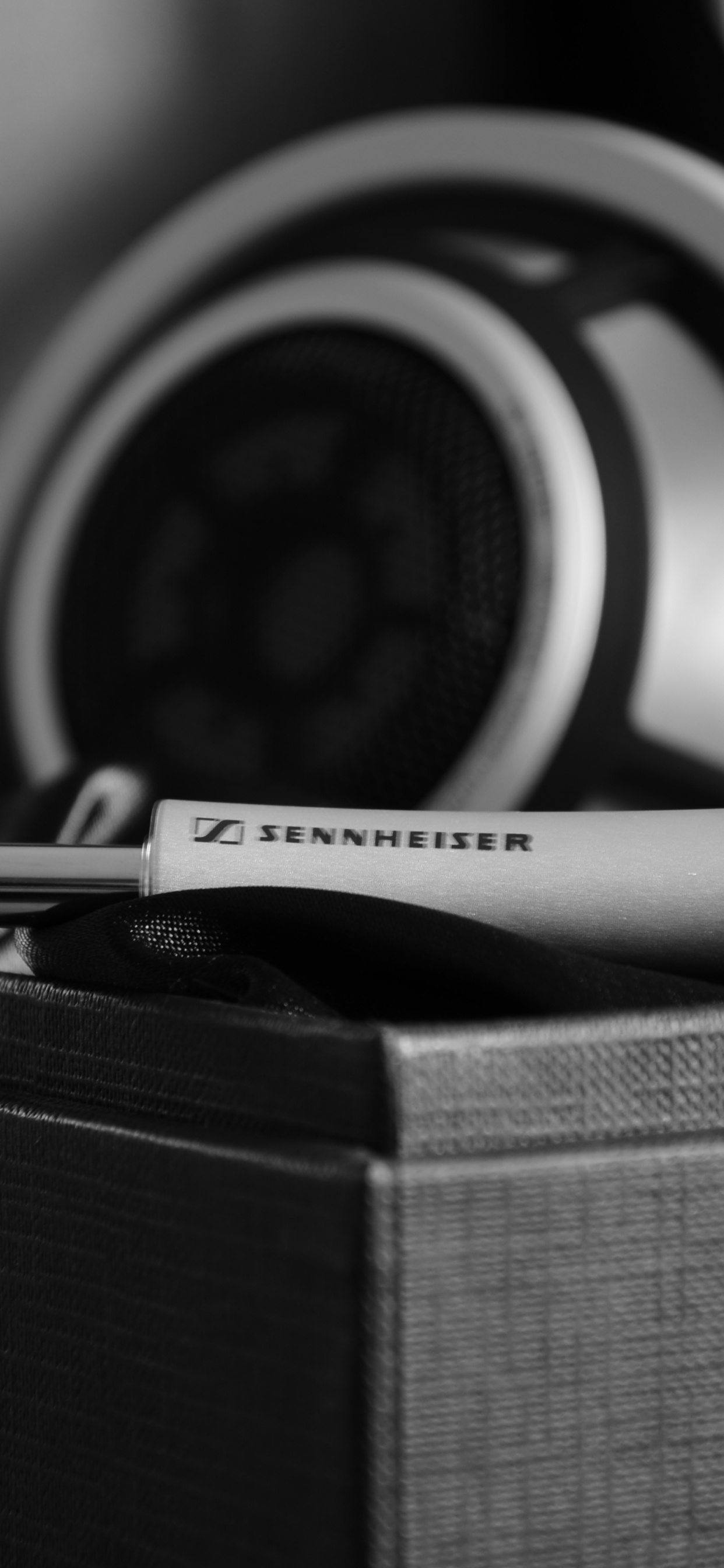 Black and White Headphones on Brown Box. Wallpaper in 1242x2688 Resolution
