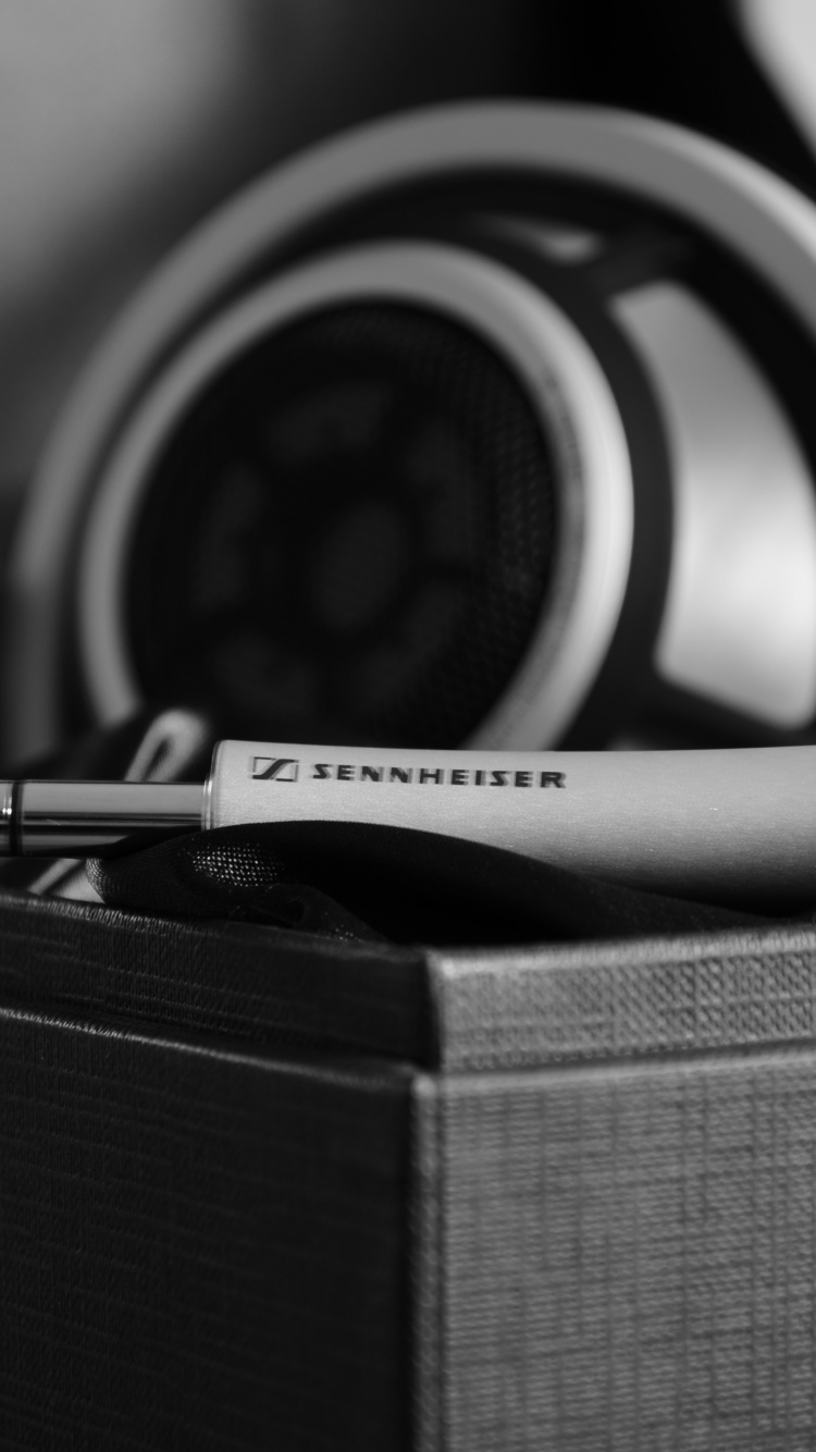 Black and White Headphones on Brown Box. Wallpaper in 750x1334 Resolution