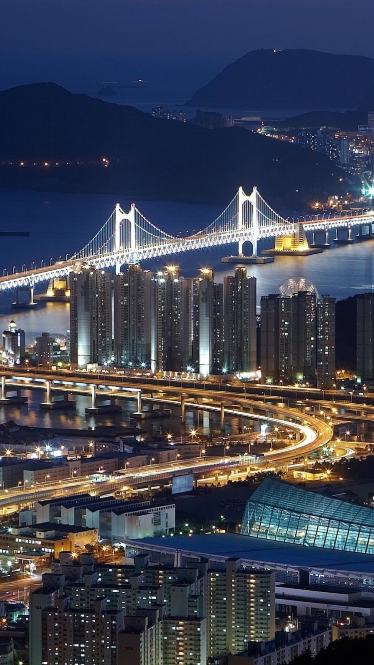 White Bridge Over Body of Water During Night Time. Wallpaper in 750x1334 Resolution