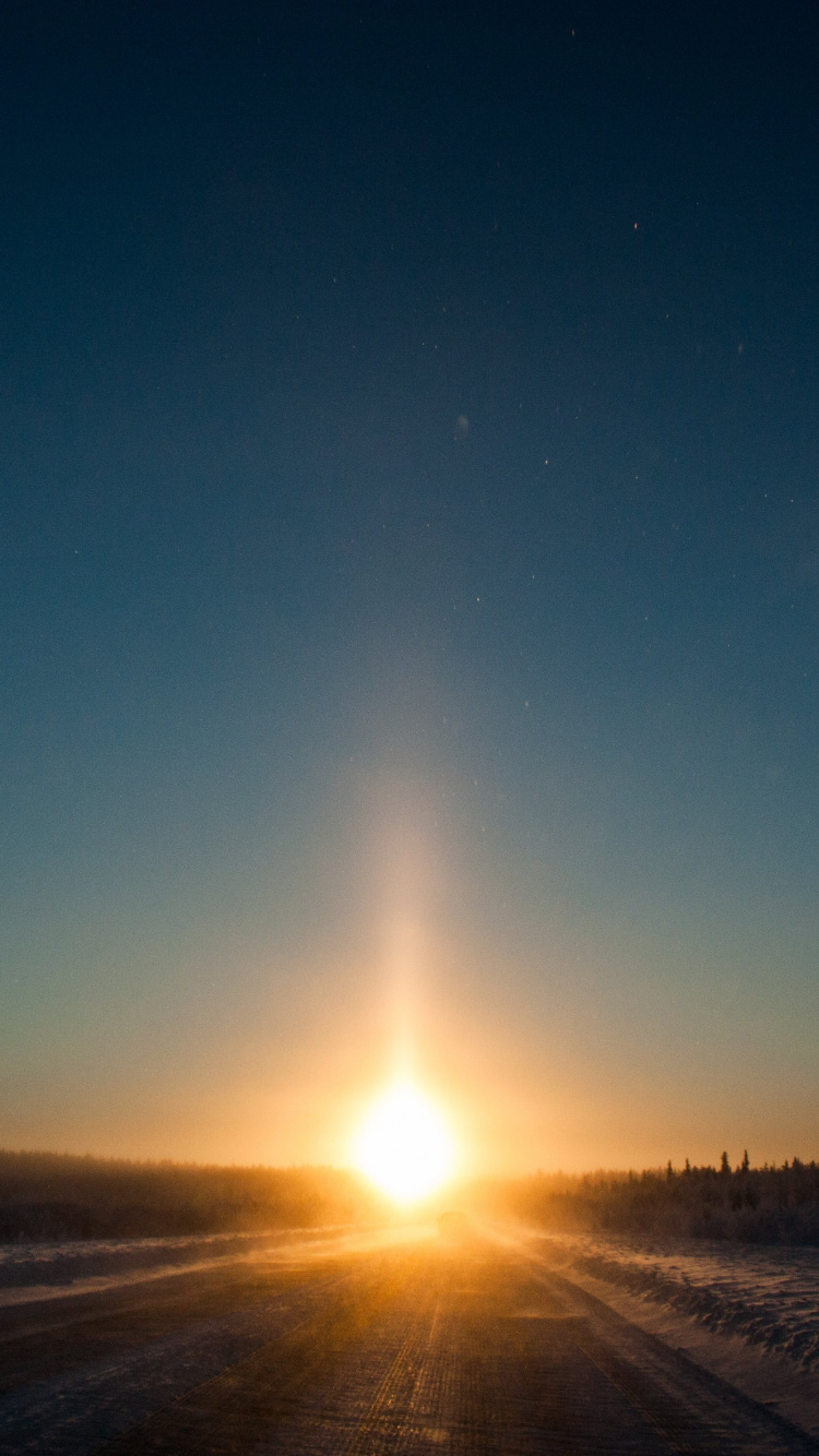 Sun Setting Over The Field. Wallpaper in 750x1334 Resolution