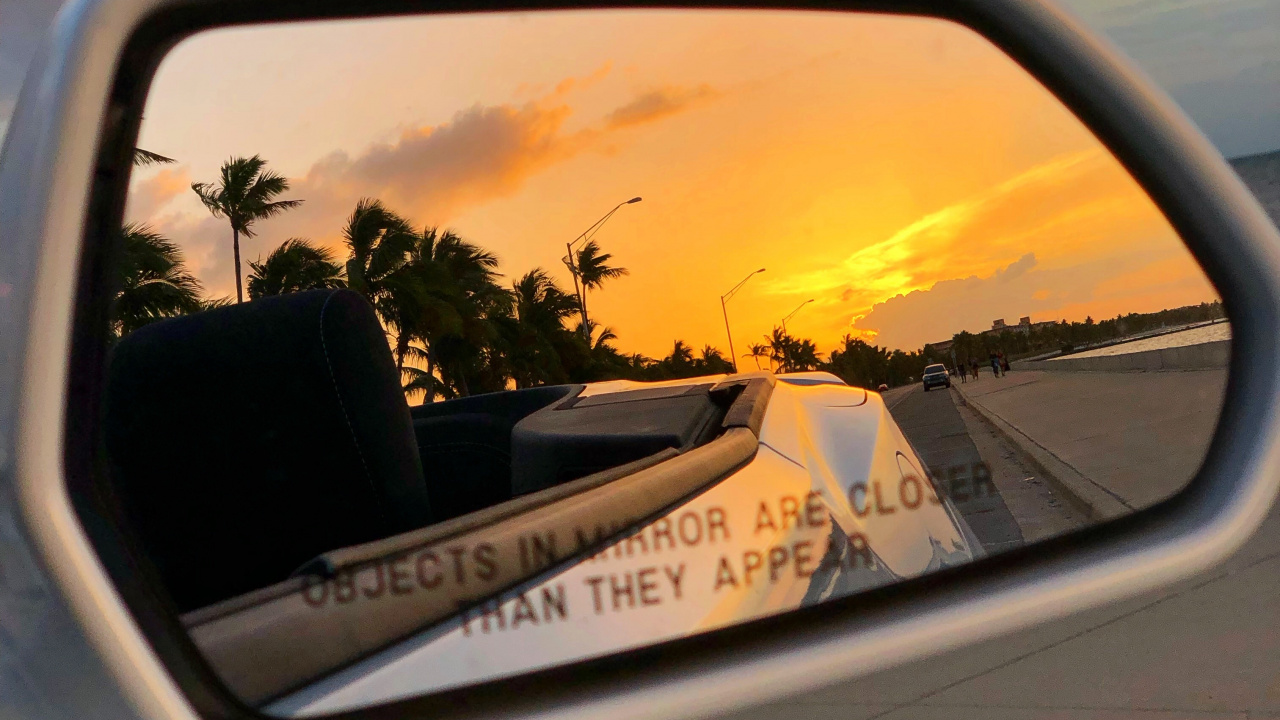 Car Side Mirror Showing White Car on Road During Sunset. Wallpaper in 1280x720 Resolution