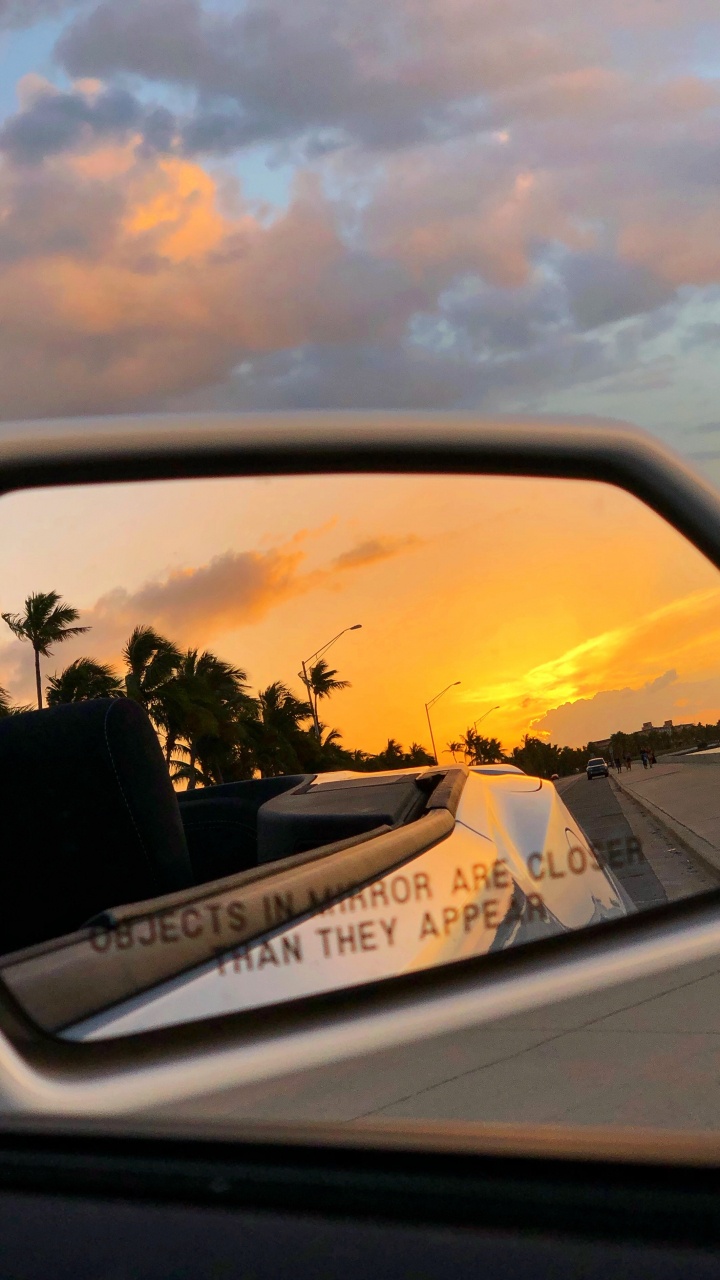 Car Side Mirror Showing White Car on Road During Sunset. Wallpaper in 720x1280 Resolution